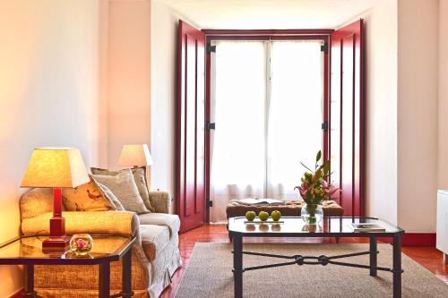 a living room with a couch and a table at Pousada Convento de Beja in Beja