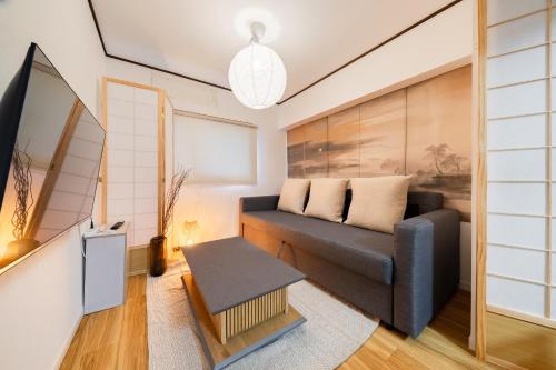 a living room with a couch and a table at Fujimi apartment601 in Tokyo