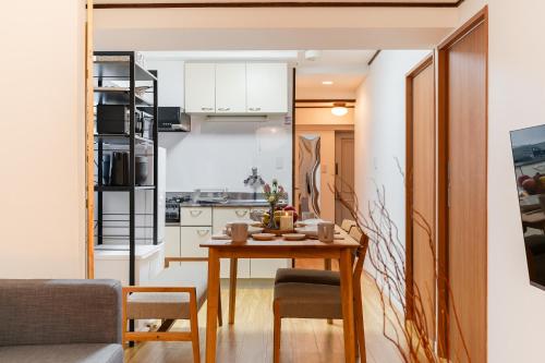 a small kitchen and dining room with a table and chairs at Fujimi apartment601 in Tokyo