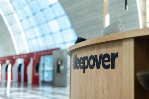 a wooden podium with the word scavenger on it at Sleepover Terminal 3, Concourse B - formerly sleep 'n fly in Dubai