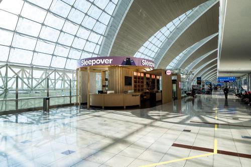 an airport terminal with a large glass ceiling at Sleepover Terminal 3, Concourse B - formerly sleep 'n fly in Dubai