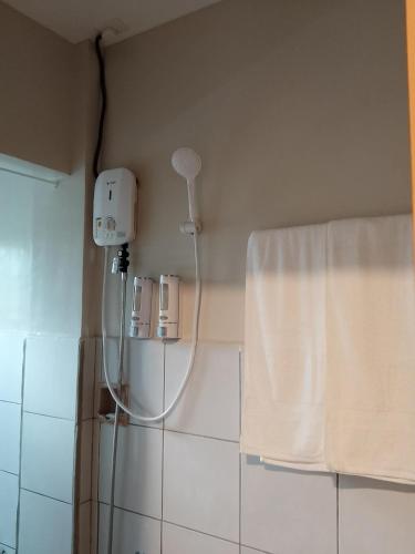 a shower in a bathroom with a white curtain at RMBC beds and breakfast in Badian