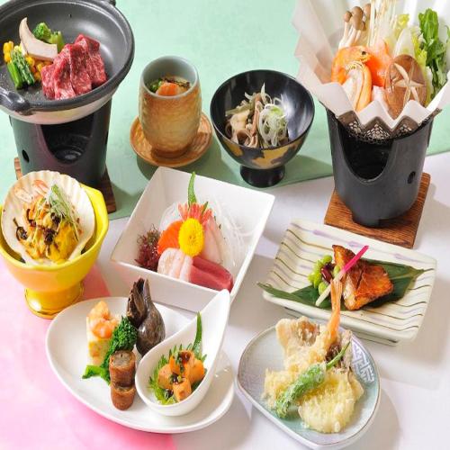a table topped with plates of food and bowls of food at Yumoto Ginsenkaku in Kamikawa