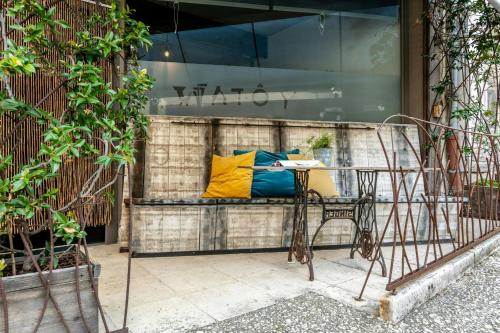 a bench with a yellow pillow on it in front of a store at Citystyle Apartment In Medieval Monflanquin in Monflanquin