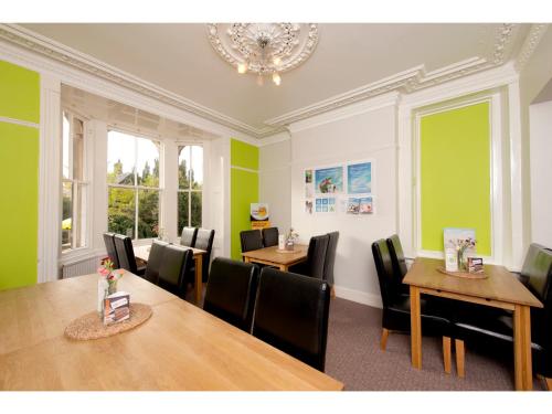 a dining room with tables and chairs and a chandelier at YHA Hathersage in Hathersage