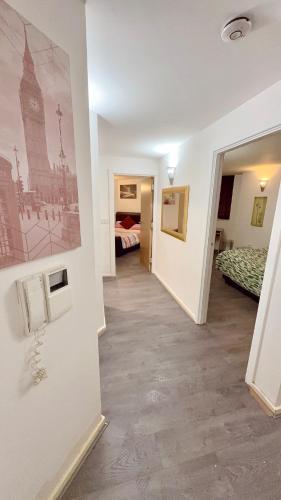 a hallway with a room with two beds and a building at 2 Spacious Double Bedroom Apartment - Bradford in Bradford
