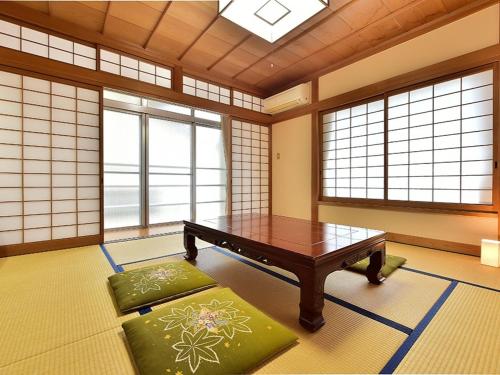 a room with a table and some windows at KKR Kinosaki Genbu in Kinosaki