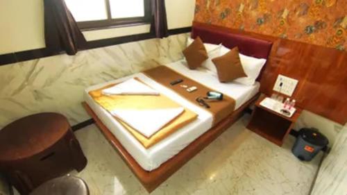 a hotel room with a bed with a window at FabHotel Star Hill in Mumbai