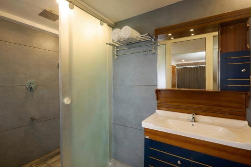 a bathroom with a sink and a mirror at Akanta Cherai Beach Resort in Cochin
