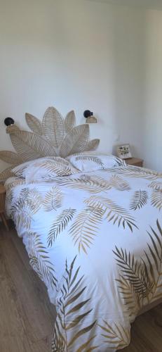 a bed with a white comforter with a plant on it at Residence Mara Dea in Galeria