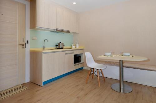 a small kitchen with a table and a sink at 7Seas in Jomtien Beach