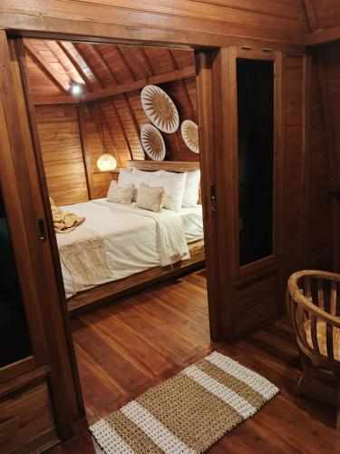 a bedroom with a bed inside of a house at Simbar Pertiwi Villa in Ubud
