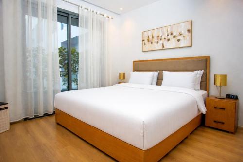 a bedroom with a large white bed and a window at City & Stadium Luxe - Tangier in Tangier