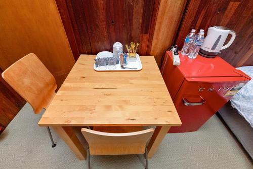a wooden table in a room with a red counter at Kin Kin Retreat in Quinninup
