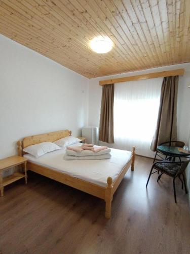 a bedroom with a large bed with a wooden ceiling at Casa Didi in Vama Veche