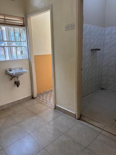 a bathroom with a sink and a shower at Next Level in Gulu