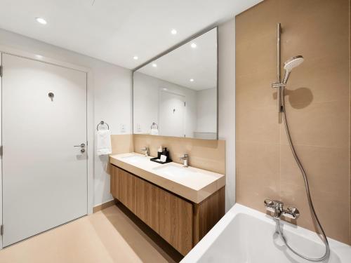 a bathroom with a sink and a shower at Royal Vista - Luxury 4BR Apartment at Downtown Views II - Downtown in Dubai