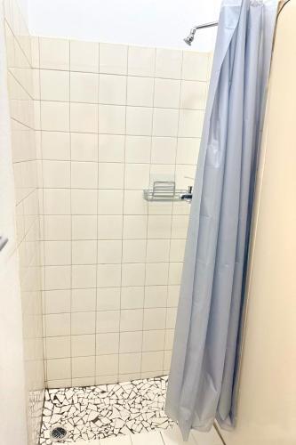 a shower with a blue shower curtain in a bathroom at Bonno Stay Suite in Gaborone