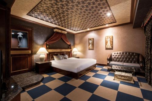 a hotel room with a bed and a couch at Hotel Pharaoh-Adult Only in Sapporo