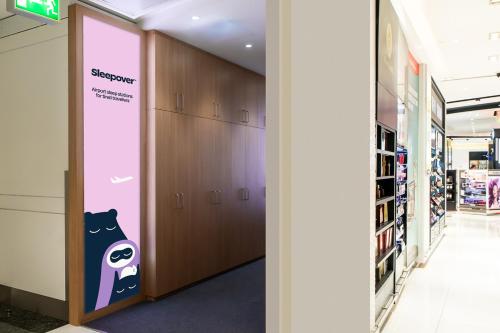 a hallway with lockers and a sign in a store at Sleepover Terminal 3, Concourse C - formerly sleep 'n fly in Dubai