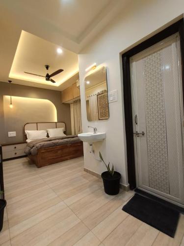 a bathroom with a sink and a bed at Desai Home Stay in Kolhapur