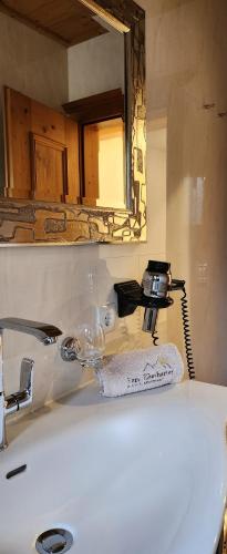 a bathroom with a sink with a mirror and a sink at Appartements Familie Eberharter in Finkenberg