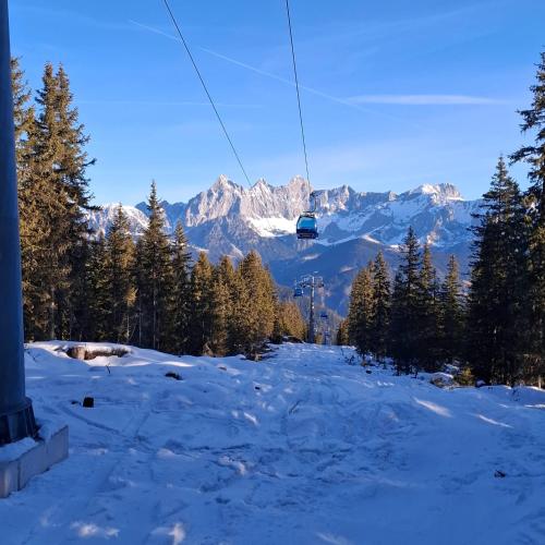 a ski lift in the mountains with snow and trees at Baby- und Kinderbauernhof Montaning in Forstau