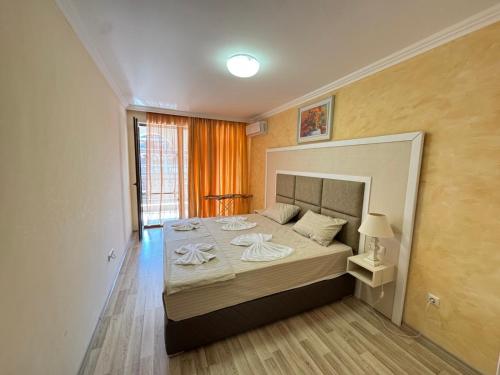 a bedroom with a large bed in a room at Private Apartments Olymp in Sveti Vlas