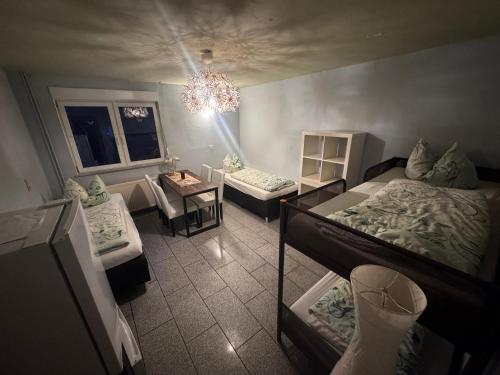 a room with two bunk beds and a chandelier at Bauernhof Privatzimmer Free WiFi Gemeinschaftsbad in Hausbreitenbach