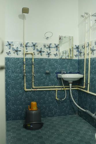 a bathroom with a sink and a mirror at Shivalik stays in Jorhat