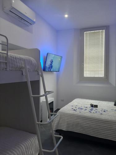 a bedroom with a bunk bed and a computer monitor at LuX Apartments in Lugo