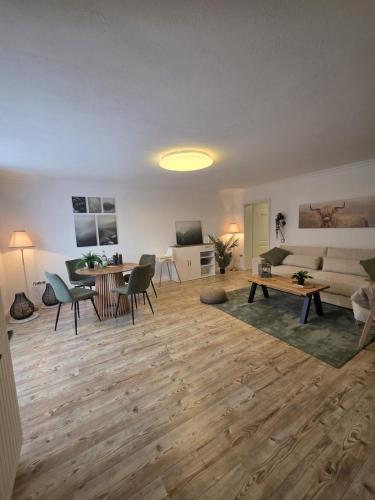 a living room with a couch and a table at Blick zur Burg in Nörten-Hardenberg