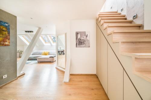 a hallway with a staircase in a house at Apartmán VALORI - 100m2 in Poděbrady