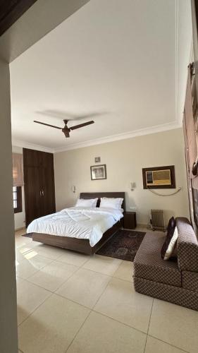 a bedroom with a bed and a ceiling fan at Silver Oak Mansion in Jalandhar