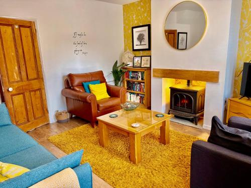 a living room with a couch and a table at Arden Holiday Lettings in Stratford-upon-Avon