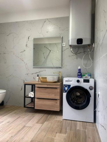 a washing machine in a bathroom with a sink at Villa BELEVITA odmor u prirodi sa grijanim bazenom in Čepelovac