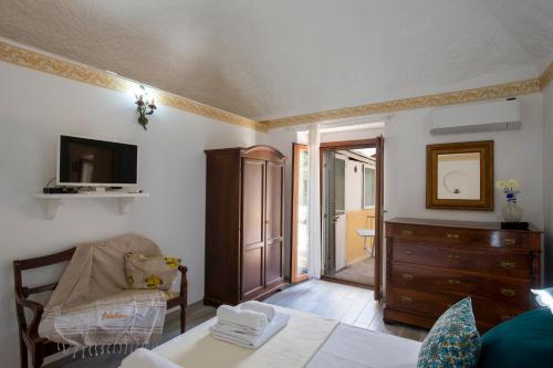 a living room with a bed and a dresser at Casa Sery in Positano