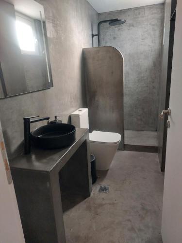 a bathroom with a sink and a toilet at Puerto Serifos in Livadi