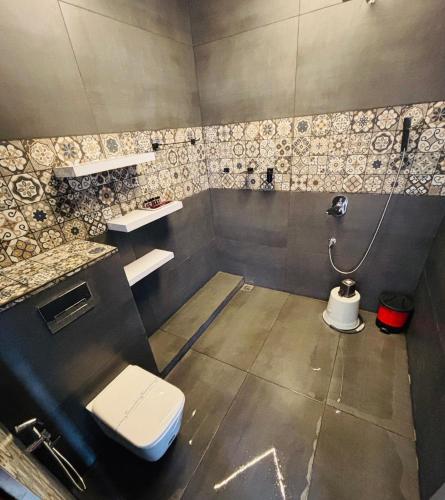 a bathroom with a toilet and a sink at West wind Resort in Meppādi