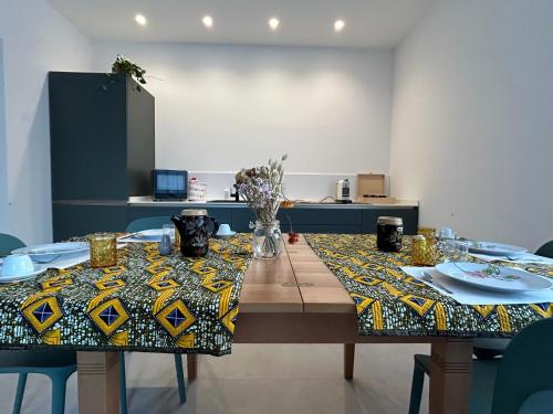 a dining room table with a table cloth on it at Casa Armadillo Guest Rooms in Trento