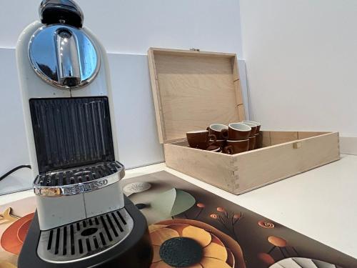 a table with a blender next to a box at Casa Armadillo Guest Rooms in Trento