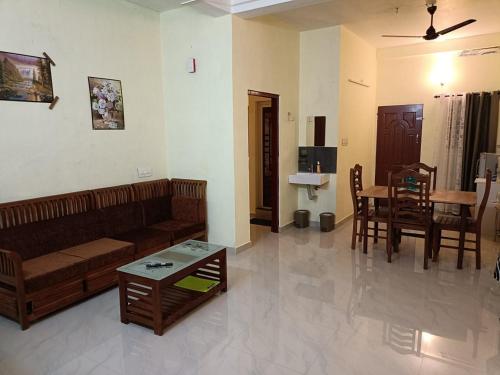 a living room with a couch and a table at Godiva Homestay in Cochin