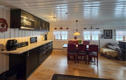 a kitchen and living room with a table and chairs at Gorgeous Home In Flatdal With Sauna in Flatdal
