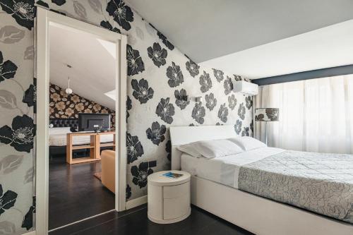 a bedroom with a bed and a mirror at Hotel Bruman in Caserta