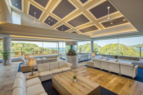 a large living room with couches and a table at Ooedo Onsen Monogatari Premium Toba Saichoraku in Toba