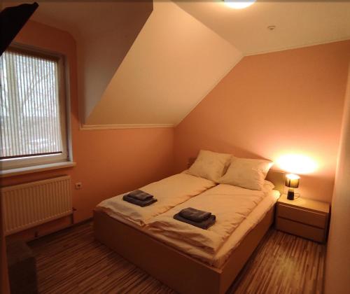 a bedroom with a bed with two towels on it at Motel M19 in Lipiny