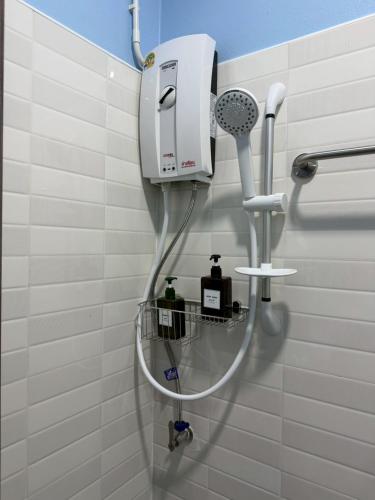 a shower in a bathroom with a hair dryer at Khaosok Bluesky Hotel in Khao Sok National Park