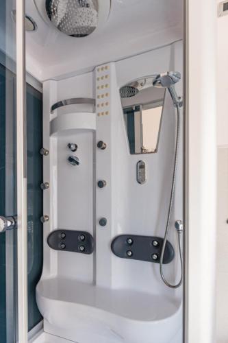 a shower in a bathroom with a mirror at Hotel Bruman in Caserta