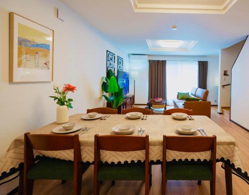 a dining room with a table and chairs at 四季歓居-新裝三層一戶建電車直達關西機場難波心斎橋天王寺住吉大社徒歩圏3ldk貸切 in Osaka