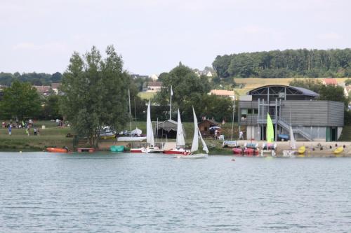 a group of boats are docked on a lake at Camping Au Coeur de Vendome in Vendôme